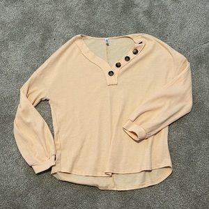 Cream-colored loose thermal top